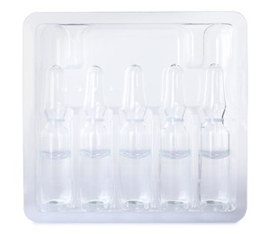 Photo of Glass ampoules with pharmaceutical product in tray on white background