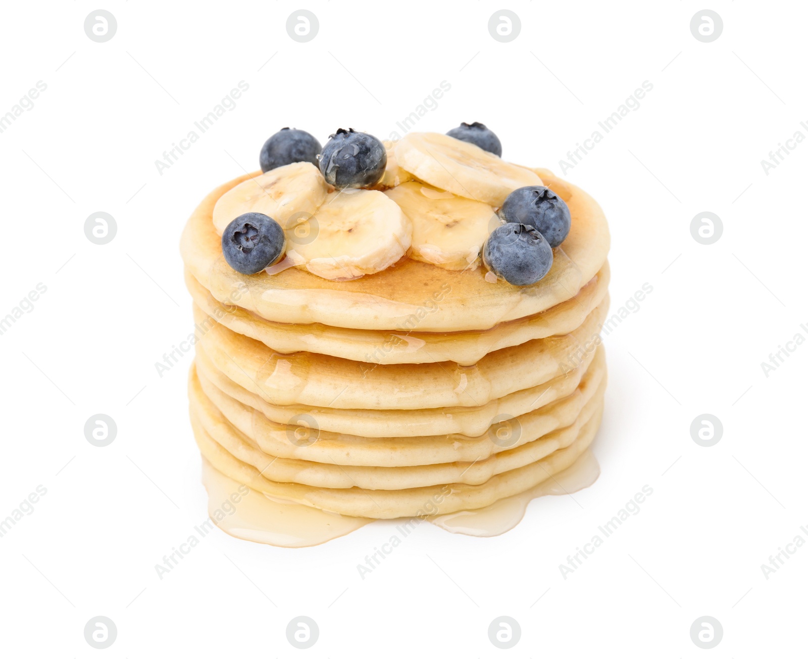 Photo of Delicious pancakes with banana slices, blueberries and honey isolated on white