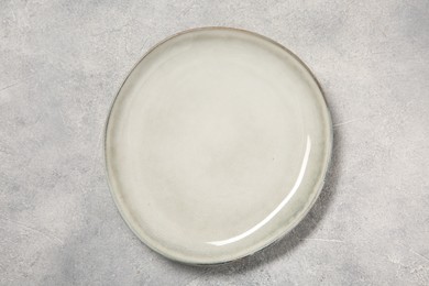 One ceramic plate on light table, top view