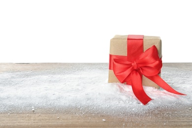 Christmas gift box and snow on table against white background