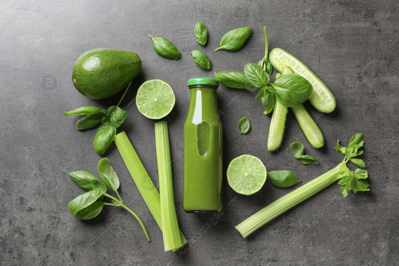 Photo of Flat lay composition with bottle of delicious detox juice and ingredients on grey background