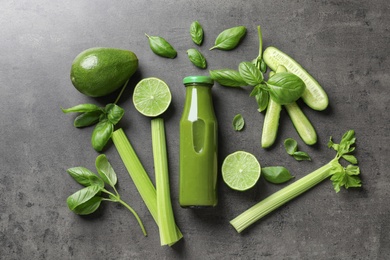 Flat lay composition with bottle of delicious detox juice and ingredients on grey background