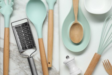 Photo of Set of different kitchen utensils on white table, flat lay