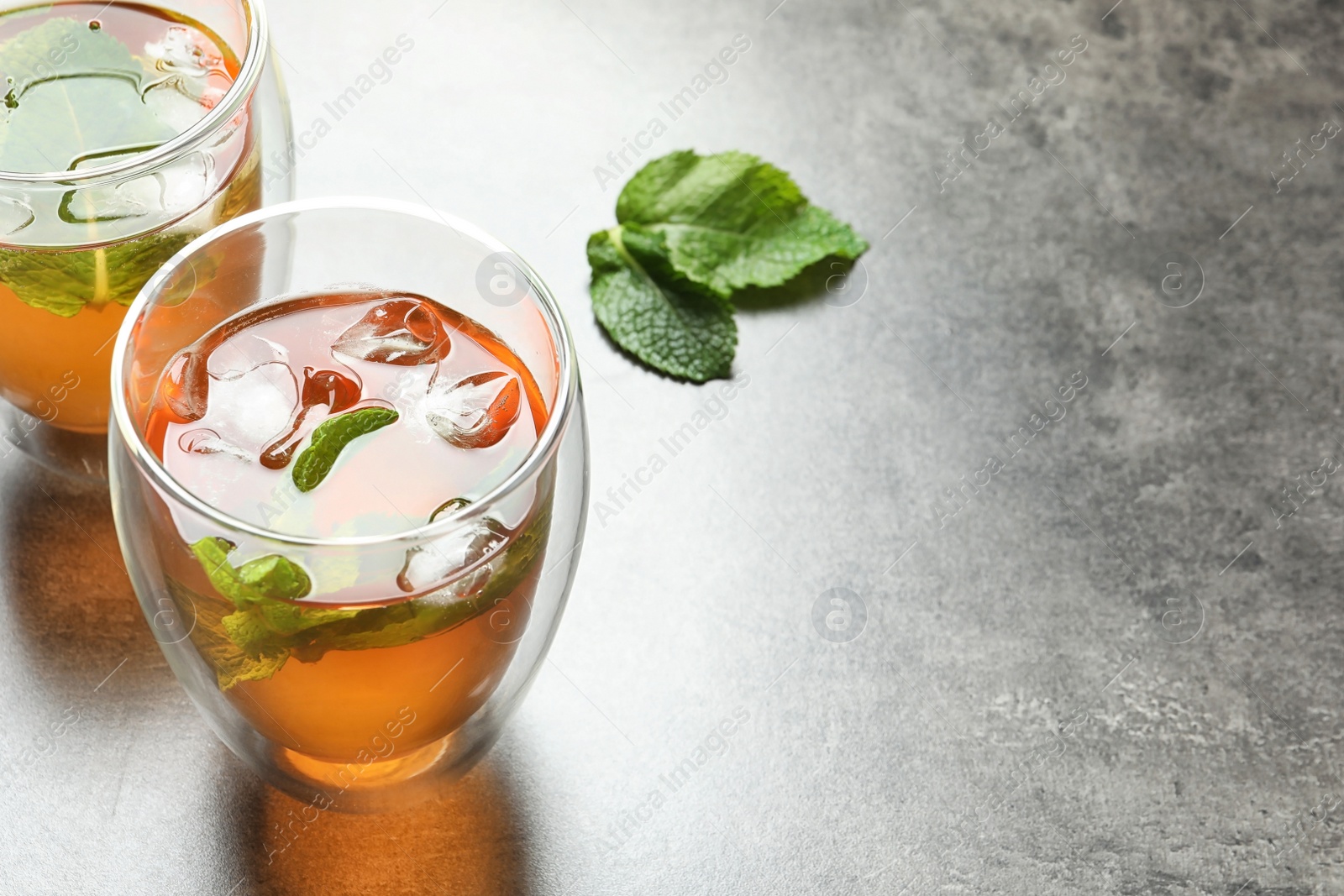 Photo of Glasses with aromatic mint tea on table