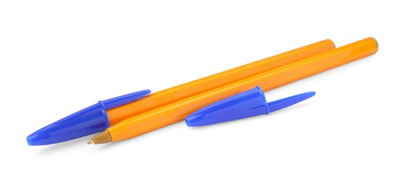 Photo of New orange plastic pens isolated on white