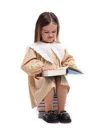 Photo of Cute little girl reading on stack of books against white background