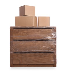 Chest of drawers wrapped in stretch film and boxes on white background