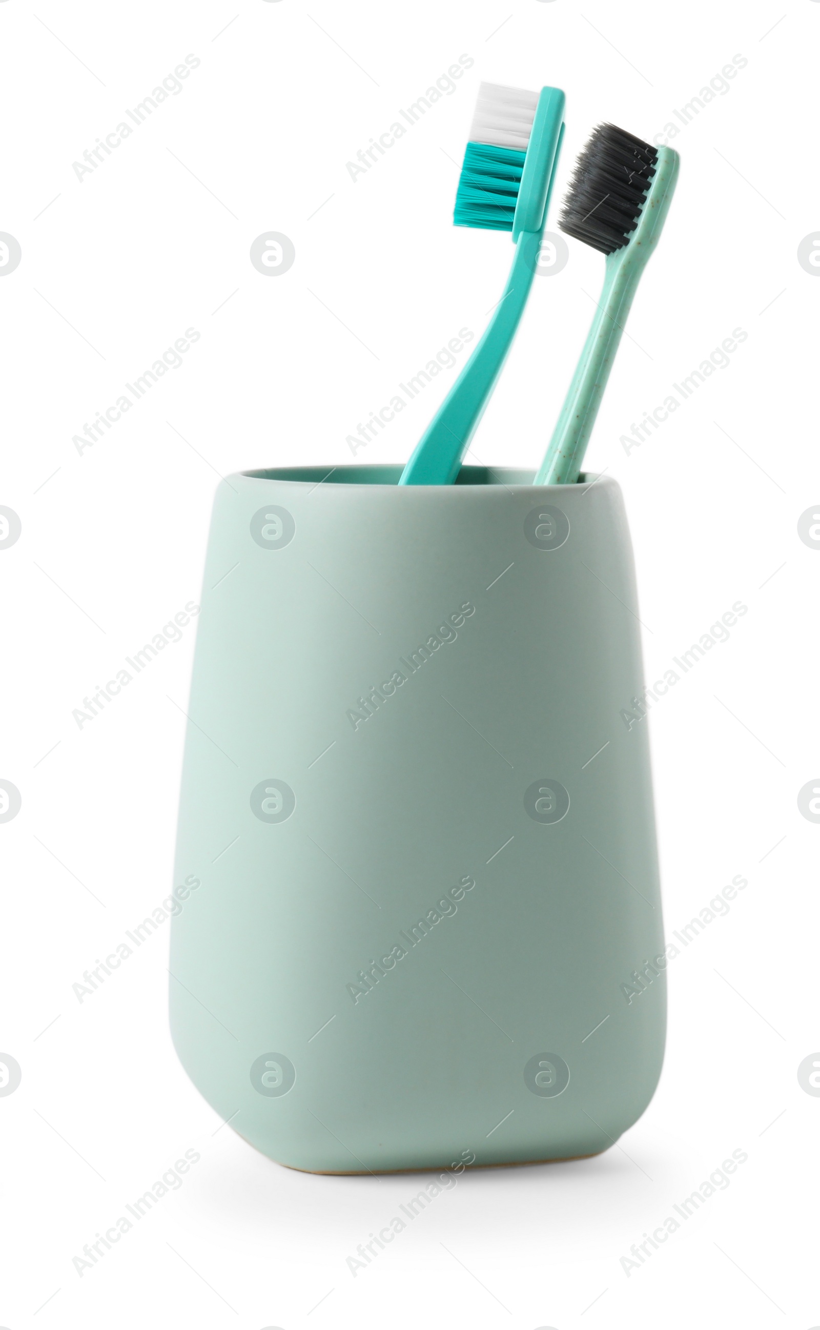 Photo of Bath accessory. Ceramic holder with toothbrushes isolated on white