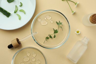 Flat lay composition with Petri dishes and plants on beige background