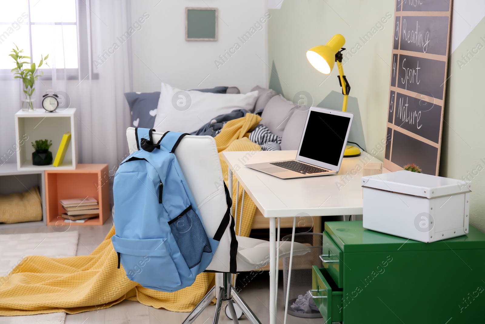 Photo of Modern child room interior with desk and laptop