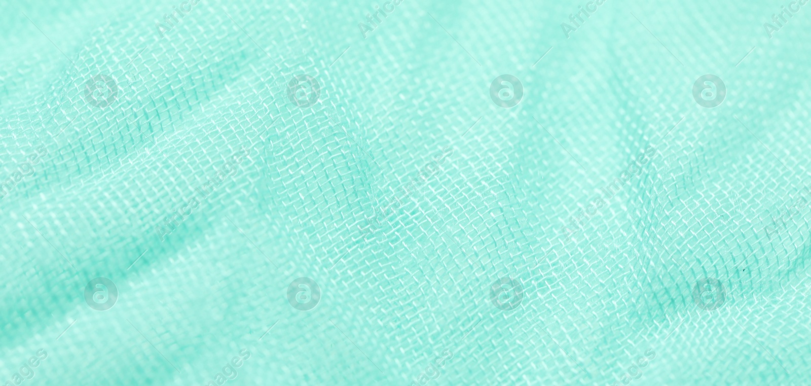 Photo of Texture of turquoise fabric as background, closeup