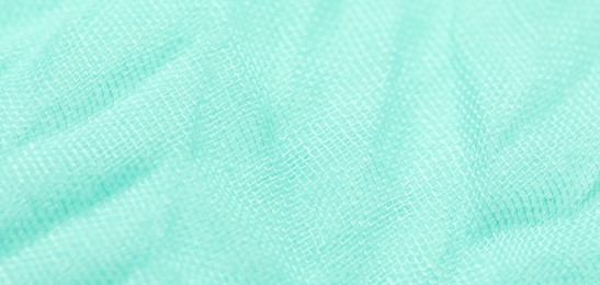 Texture of turquoise fabric as background, closeup