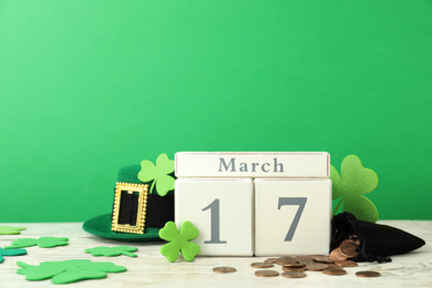 Composition with block calendar on white wooden table. St. Patrick's Day celebration