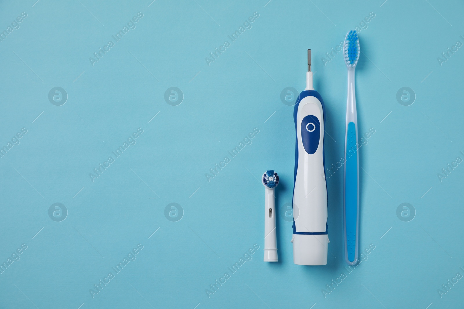 Photo of Electric and plastic toothbrushes on turquoise background, flat lay. Space for text