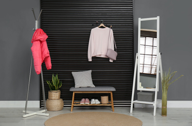 Hallway interior with stylish furniture, clothes and accessories