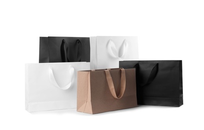 Paper shopping bags with comfortable handles on white background. Mockup for design