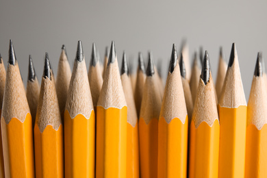 Photo of Many graphite pencils on grey background, closeup