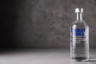 MYKOLAIV, UKRAINE - OCTOBER 04, 2019: Absolut vodka on table against grey background. Space for text