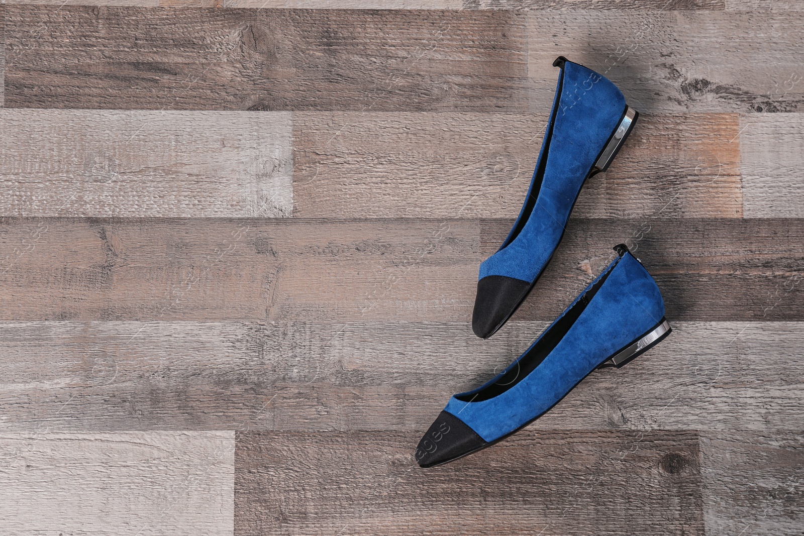 Photo of Pair of female shoes on wooden background, top view