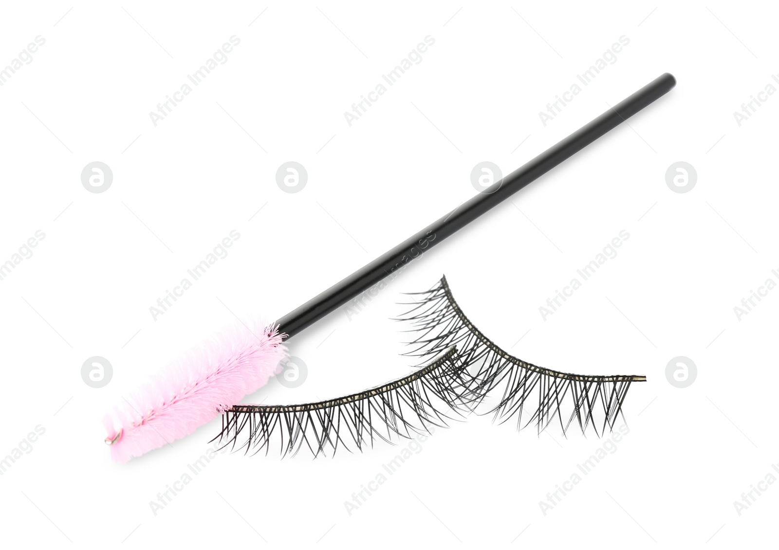 Photo of Fake eyelashes and brush on white background