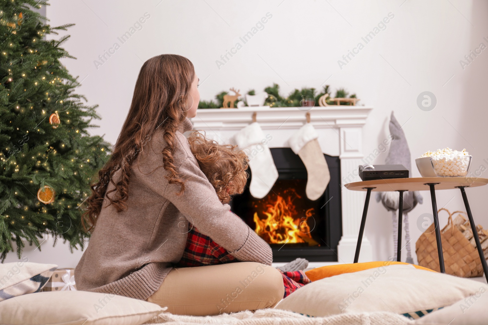 Photo of Mother and son watching movie via video projector at home