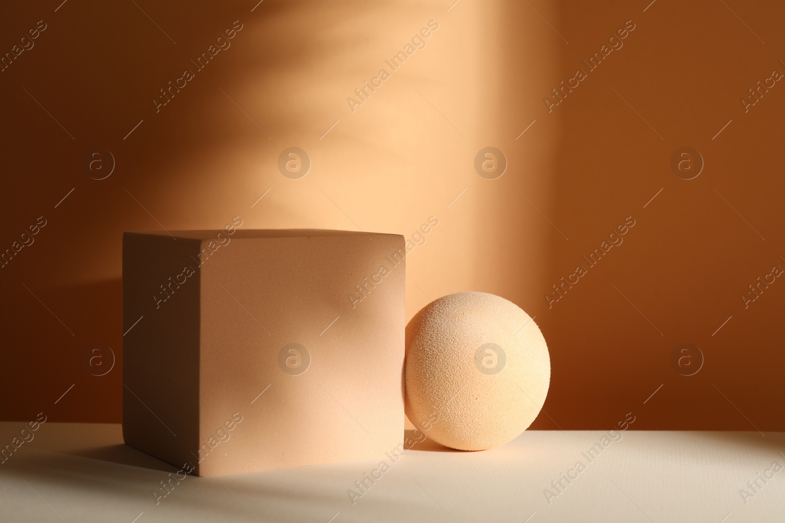 Photo of Presentation of product. Podiums and shadows on orange background. Space for text