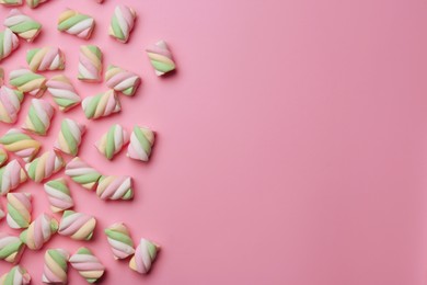 Photo of Delicious colorful marshmallows on pink background, flat lay. Space for text