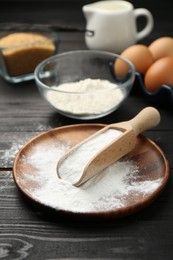 Baking powder and other products on black wooden table