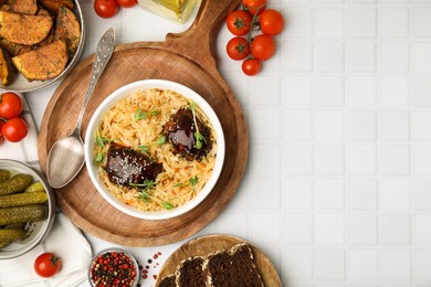 Photo of Bowl with sauerkraut and chicken served on white table, flat lay. Space for text