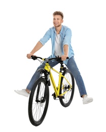 Photo of Handsome young man riding bicycle on white background