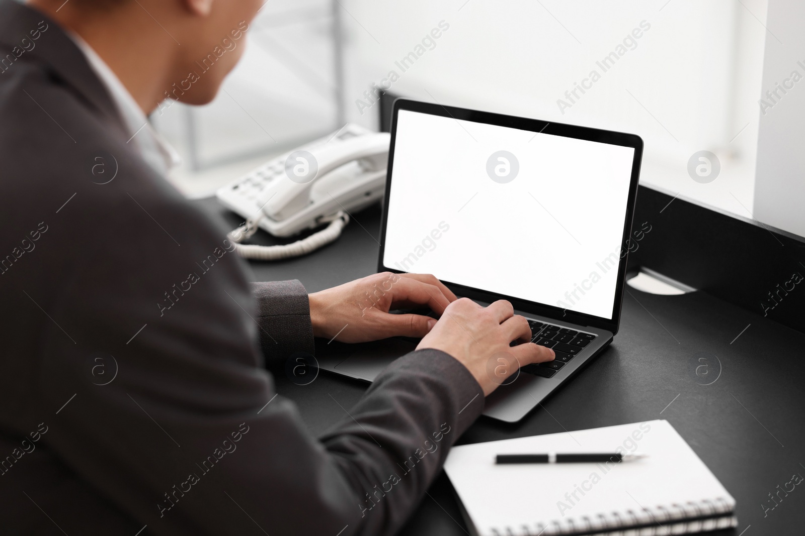 Photo of Man watching webinar at table in office, closeup