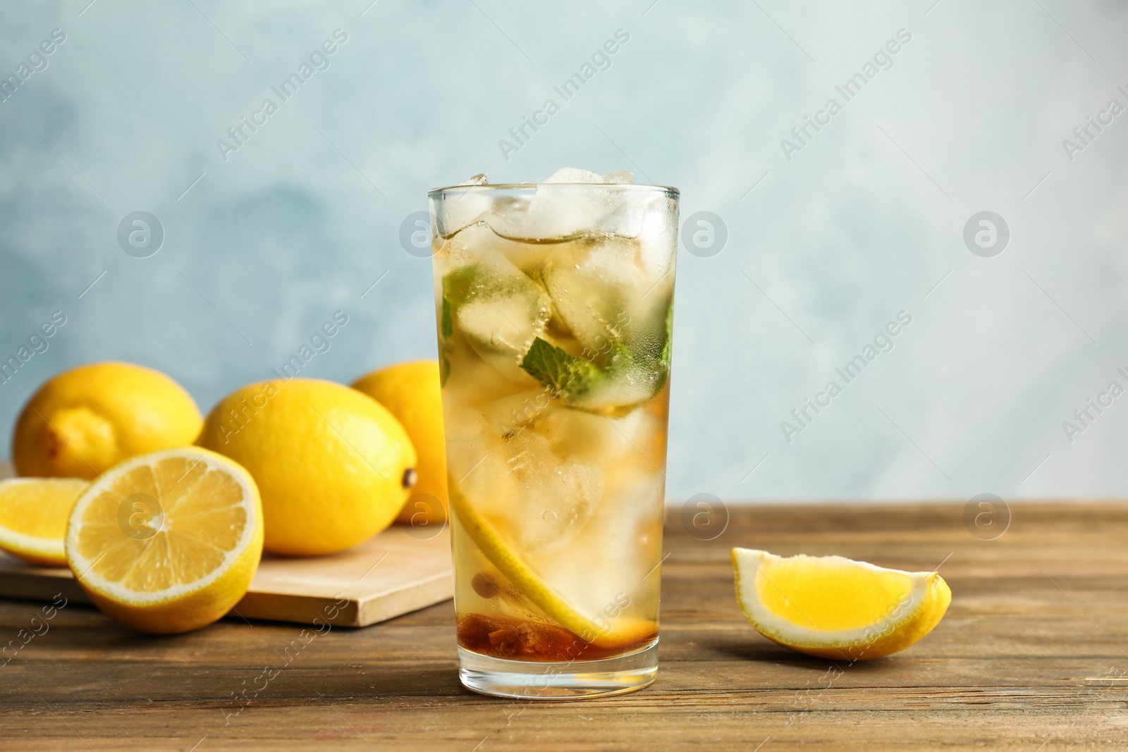 Photo of Glass with delicious mint julep cocktail on wooden table