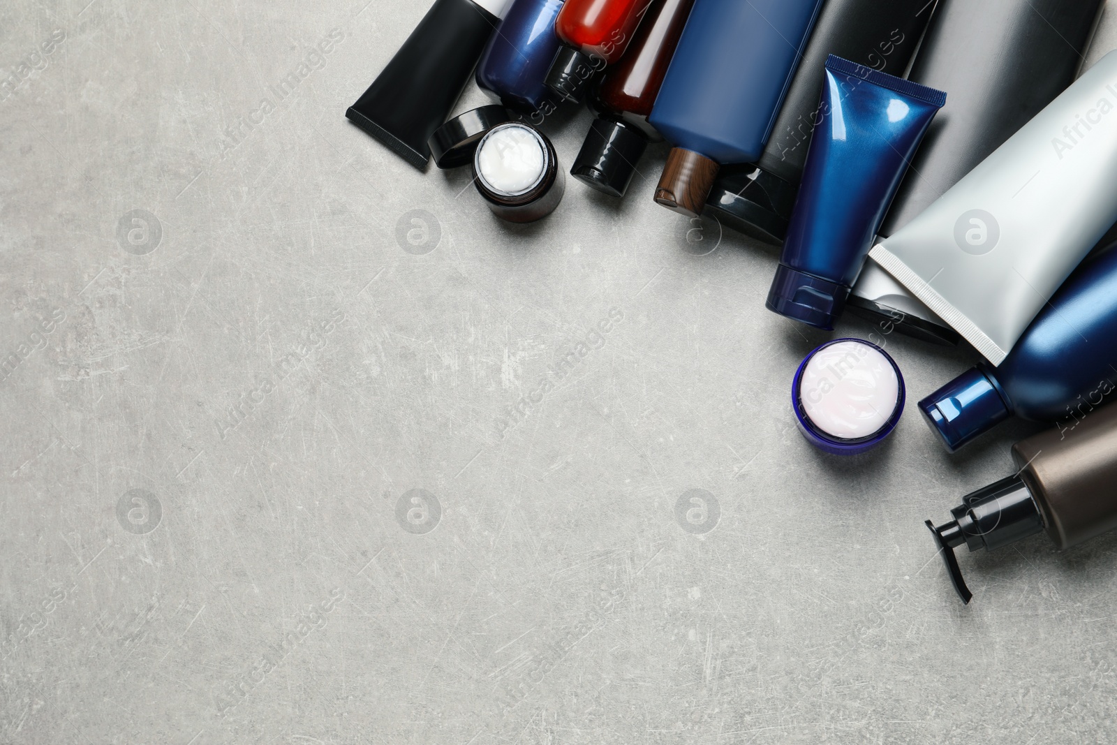 Photo of Facial cream and other men's cosmetic on light grey stone table, flat lay. Mockup for design