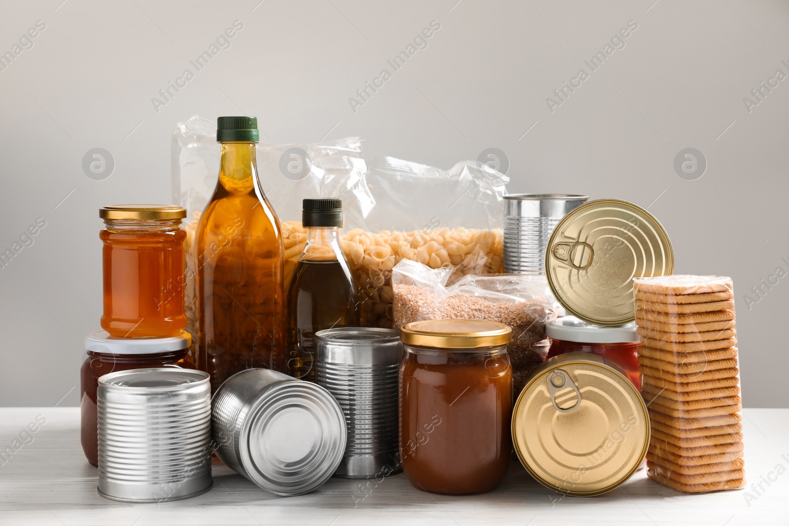 Photo of Different products on white wooden table. Food donation