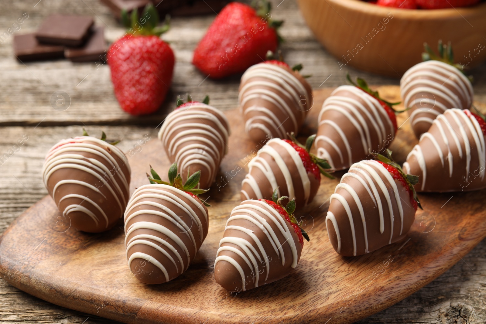 Photo of Delicious chocolate covered strawberries on wooden table, closeup