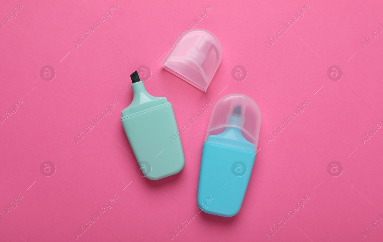 Photo of Colorful markers on pink background, flat lay