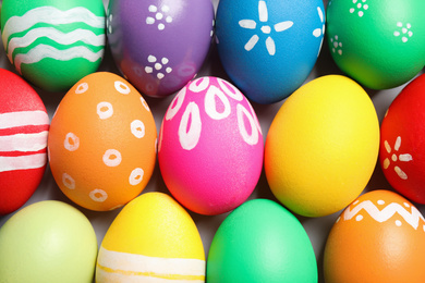 Photo of Colorful Easter eggs with different patterns as background, top view