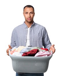 Young man with basket full of laundry on white background