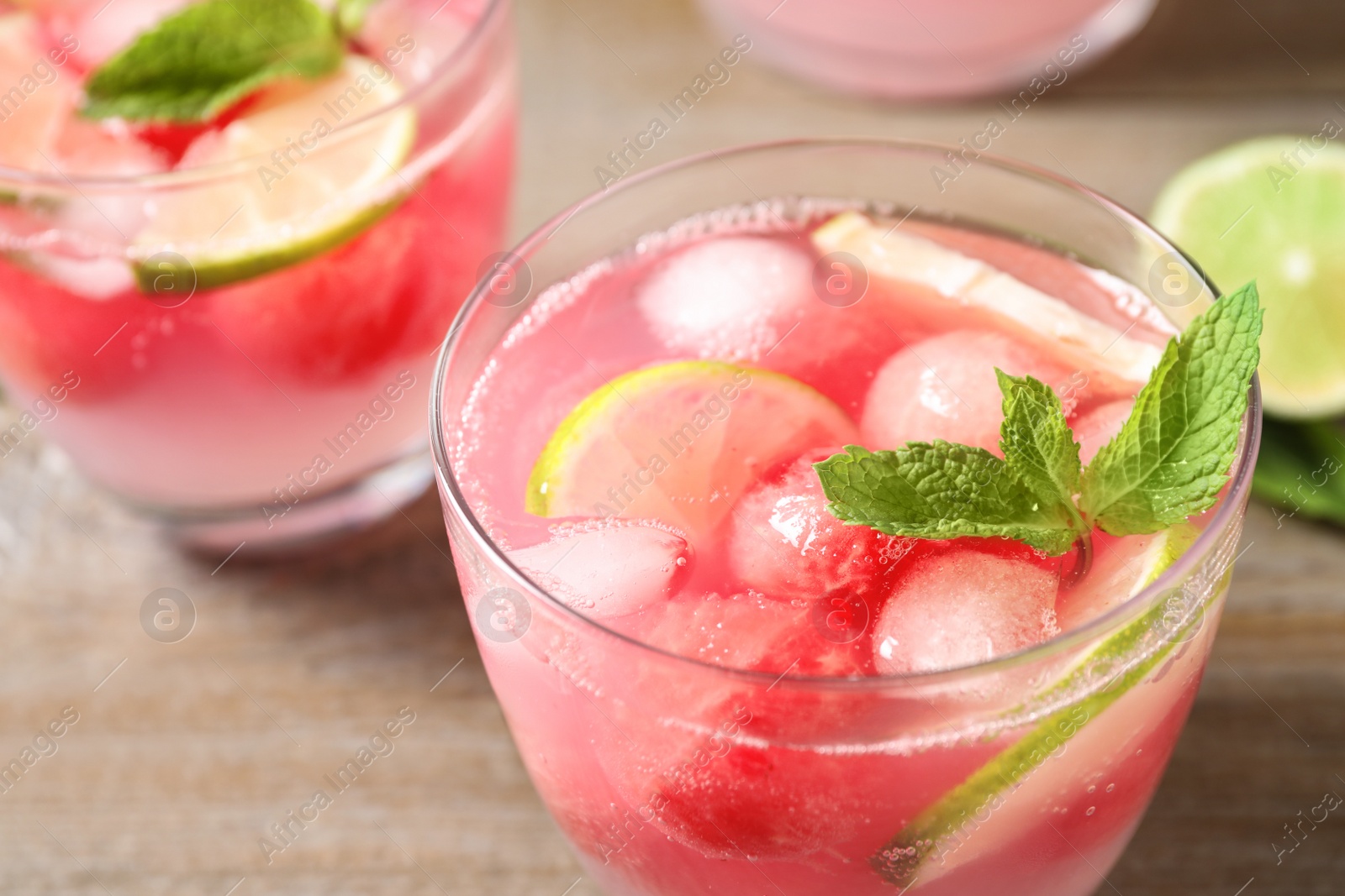 Photo of Tasty refreshing watermelon drink on wooden table, closeup