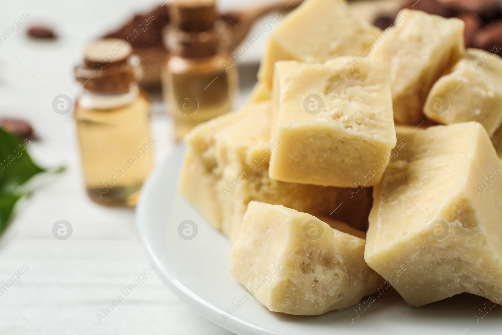 Photo of Organic cocoa butter on wooden table, closeup