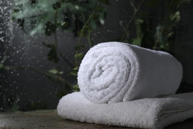 Photo of White terry towels on table in bathroom, space for text