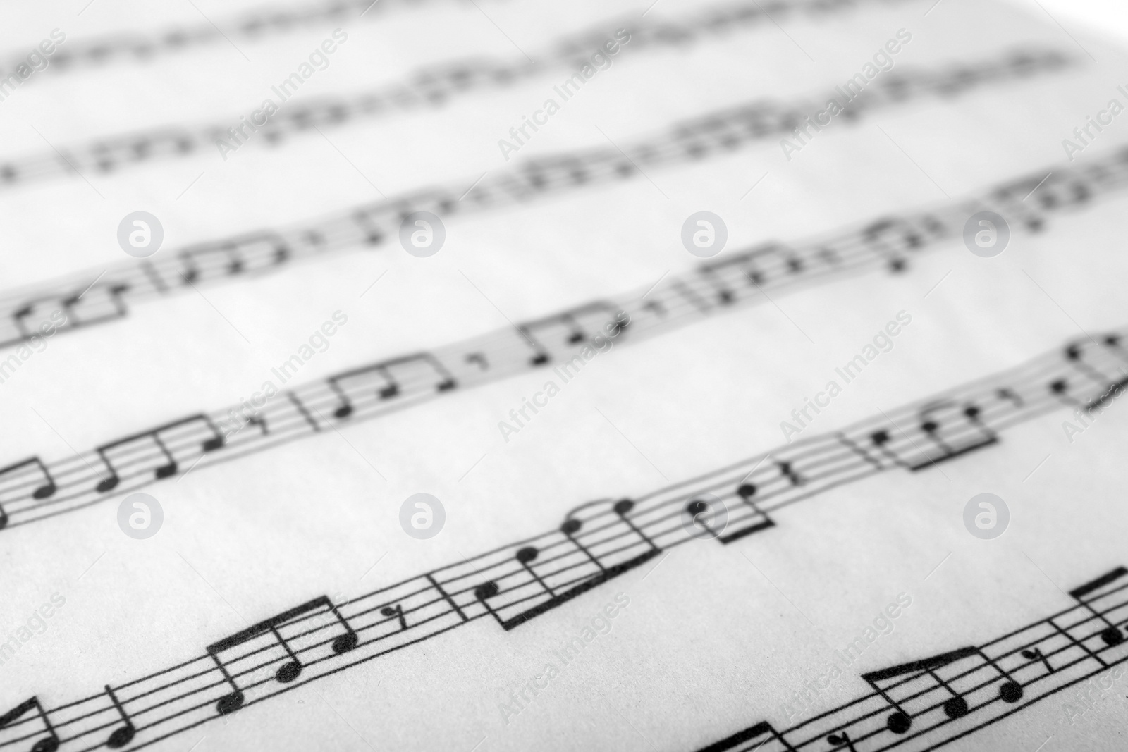 Photo of Sheet with music notes as background, closeup