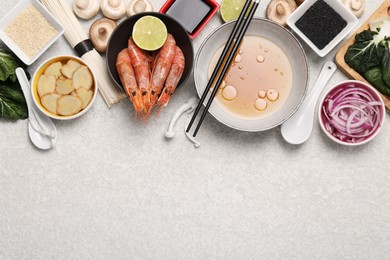 Cooking delicious ramen soup. Different ingredients on beige table, flat lay. Space for text