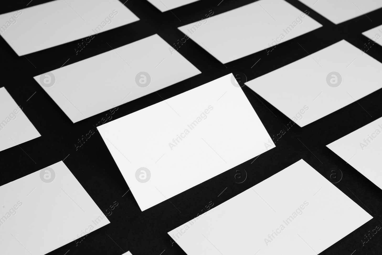 Photo of Blank business cards on black background, closeup. Mockup for design