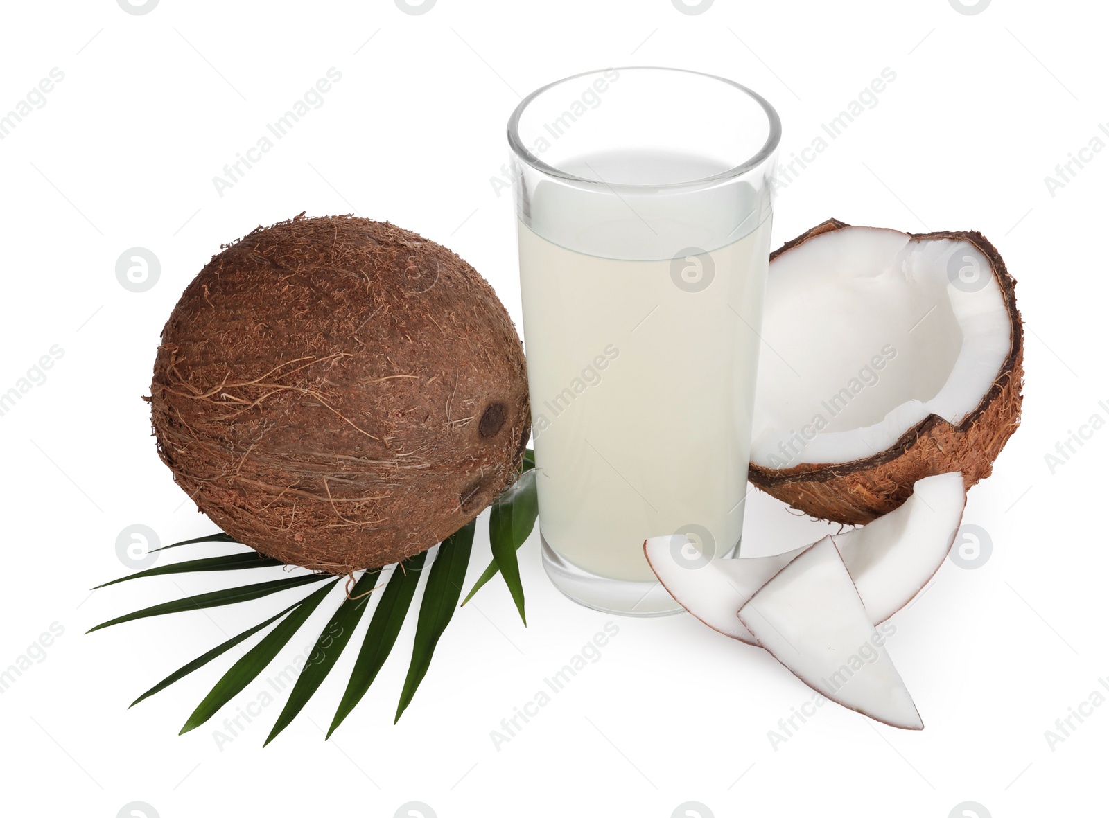 Photo of Glass of coconut water, leaf and nuts isolated on white