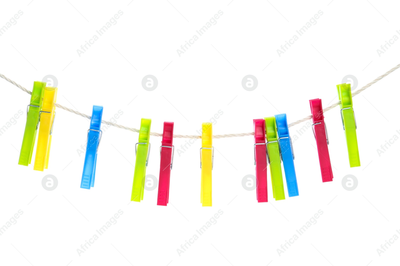 Photo of Colorful plastic clothespins hanging on rope against white background