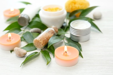 Beautiful composition with spa cosmetics and candles on light background