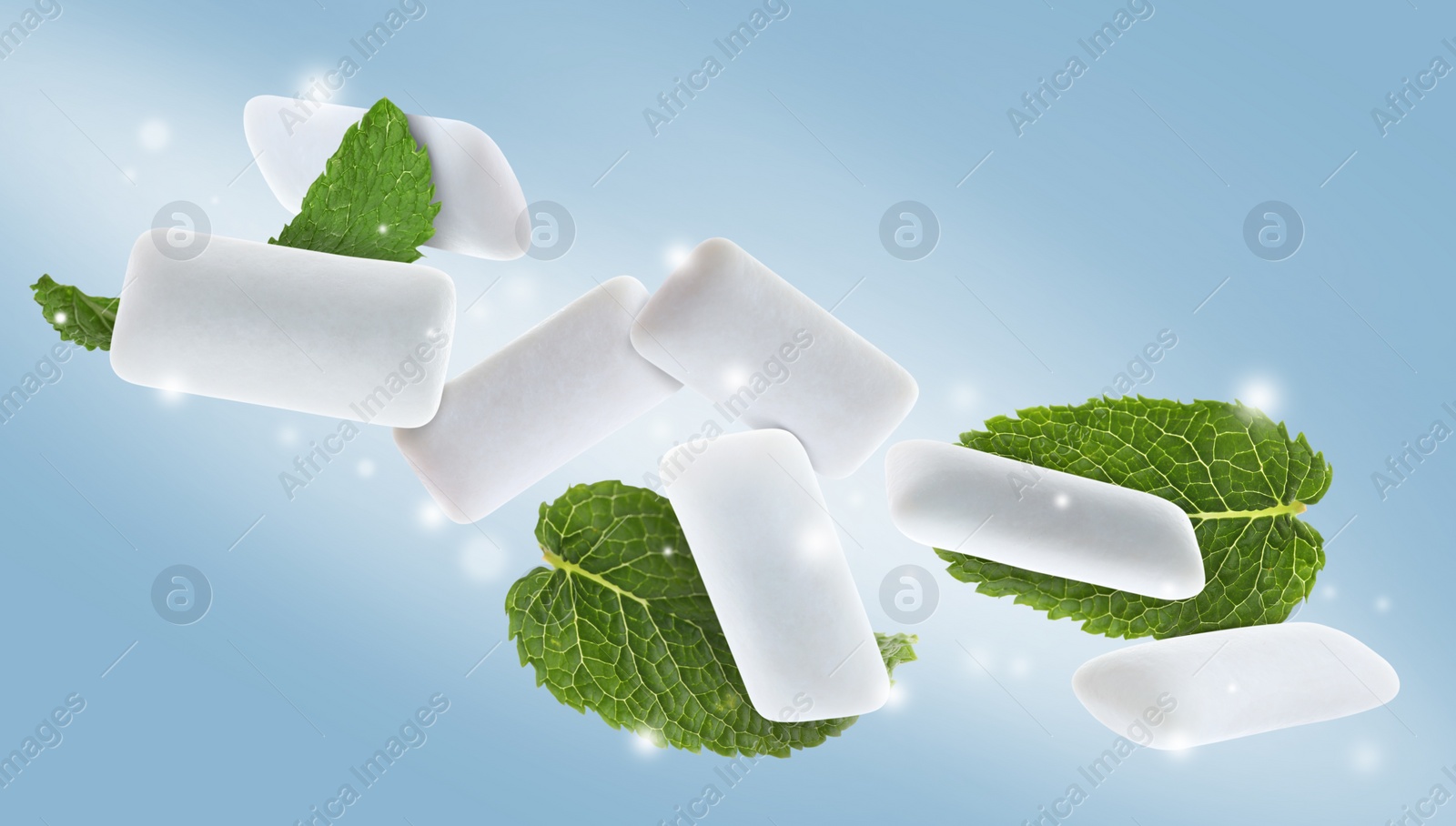 Image of Fresh mint leaves and chewing gum pads falling around lights on light blue background