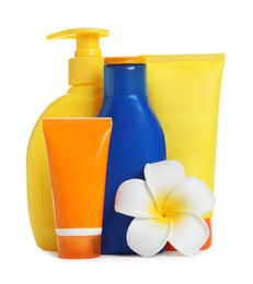 Composition with sun protection cosmetic products and flower on white background