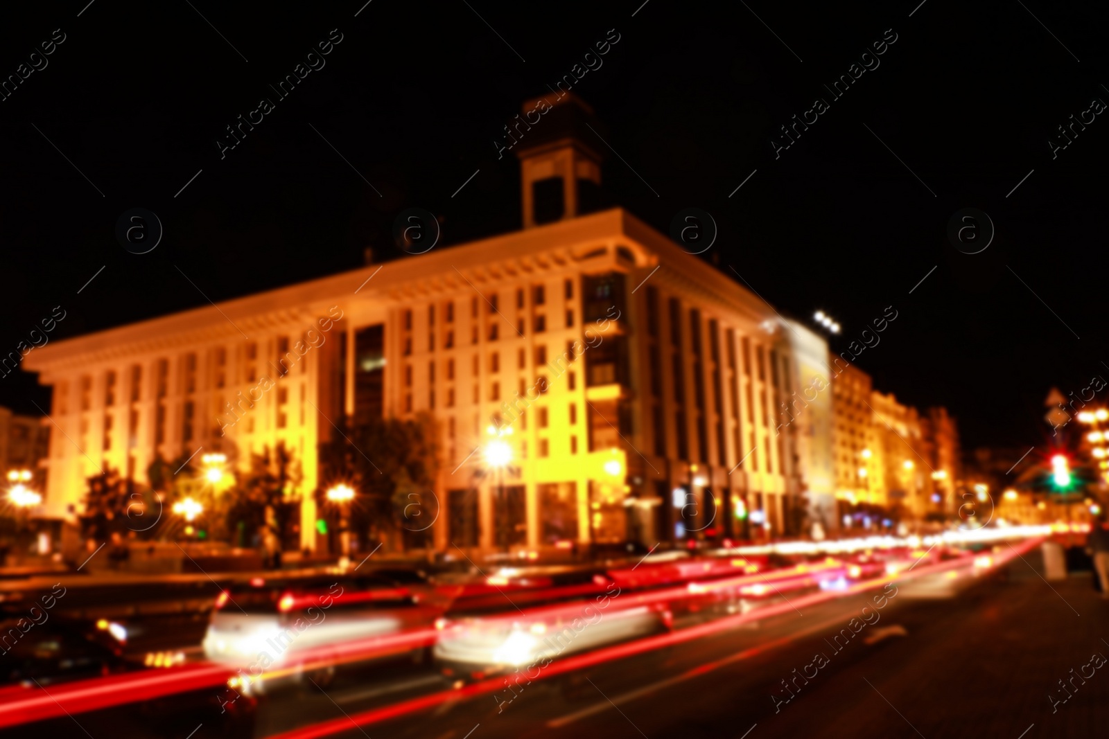 Photo of View of night cityscape with illuminated building and light trails